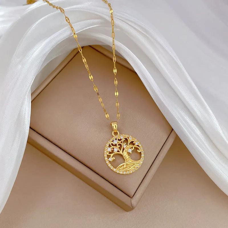 Gold-plated necklace with lucky tree rhinestone pendant and mother pearl centrepiece on an adjustable chain.
