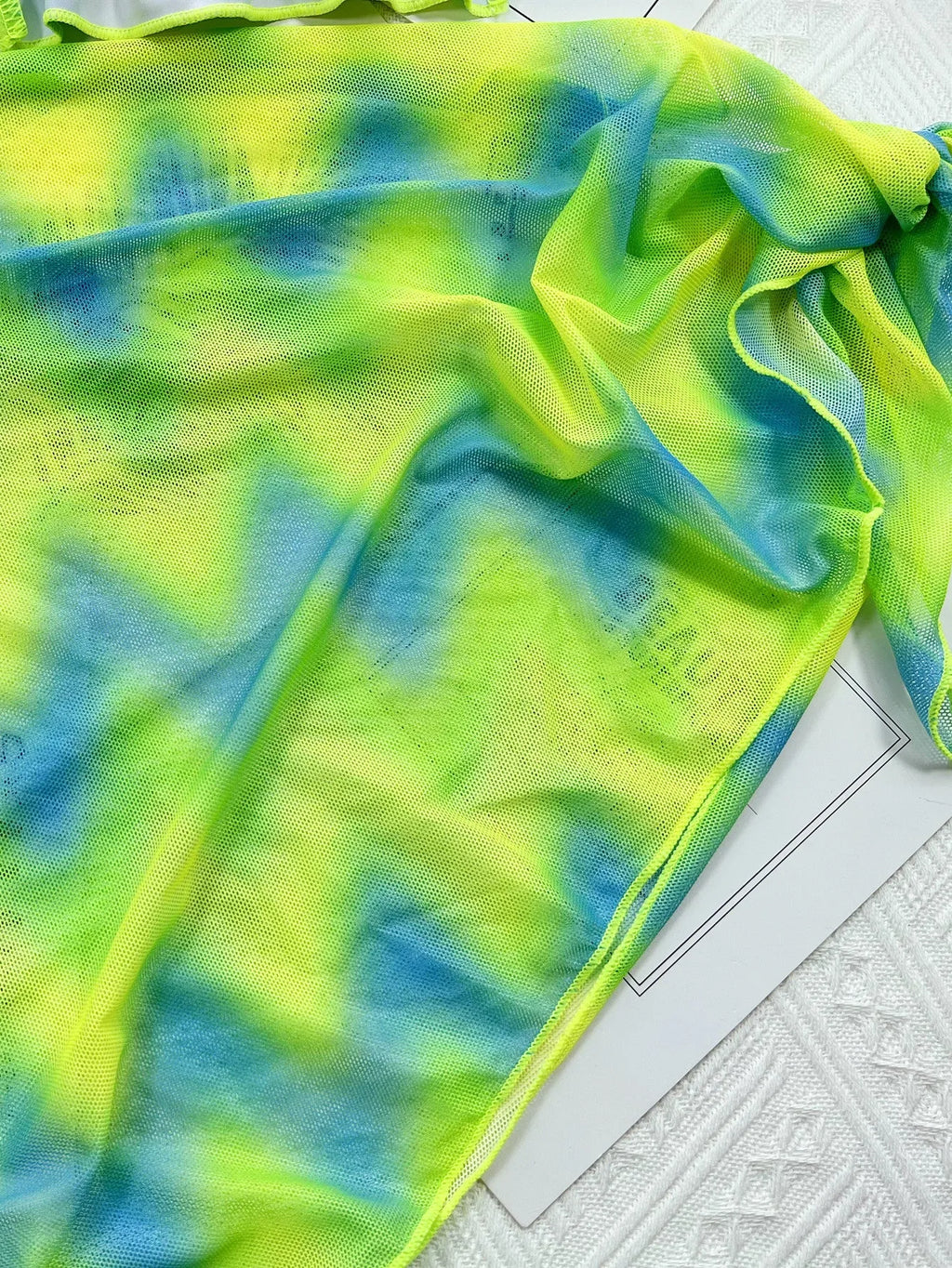 Green tie dye women's two-piece swimsuit bikini set with bra, briefs, and skirt.