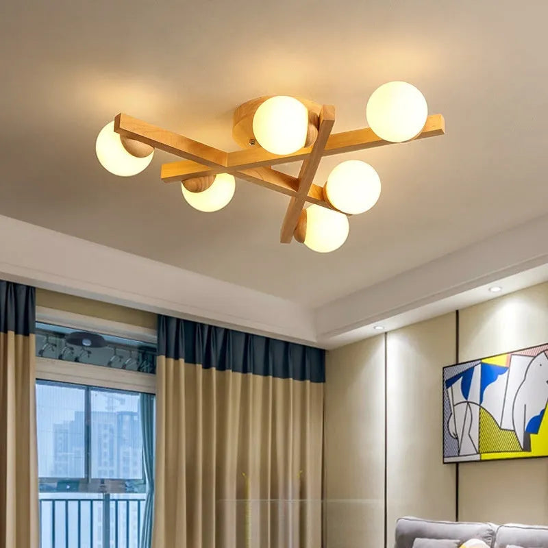 Wooden style modern Nordic ceiling light with three heads, installed in a living room.