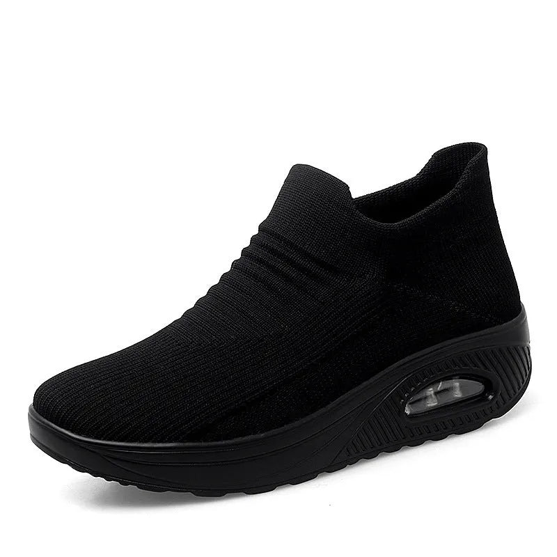 Women's platform slip-on rocking shoes in black, side view, Flyknit upper, round toe