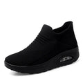 Women's platform slip-on rocking shoes in black, side view, Flyknit upper, round toe