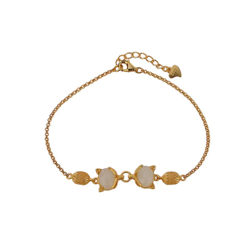 Close-up of a women's 925 silver bracelet with a hand-carved fox charm on an adjustable chain.