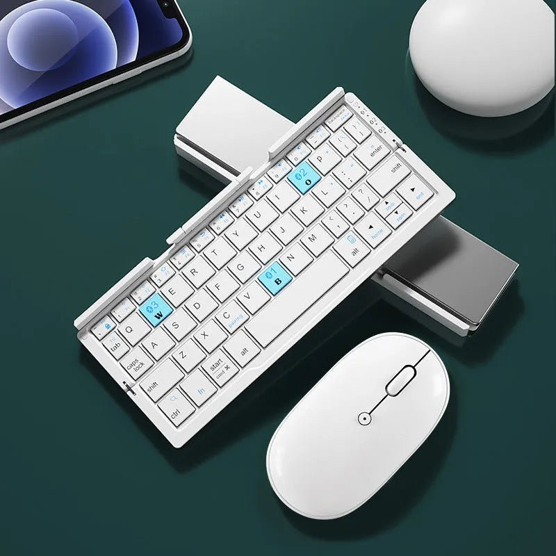 Folded aluminium Bluetooth keyboard showing compact size next to unfolded version with tablet on stand