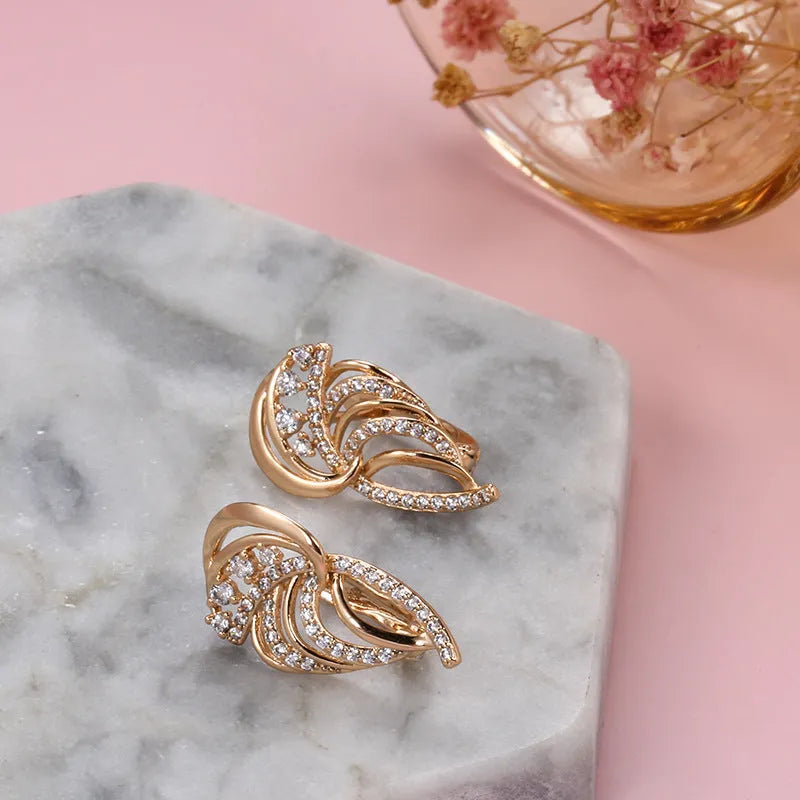 Women's copper ear clips with wing design featuring micro inlaid zircon detailing and gold-plated finish in H0195 colour