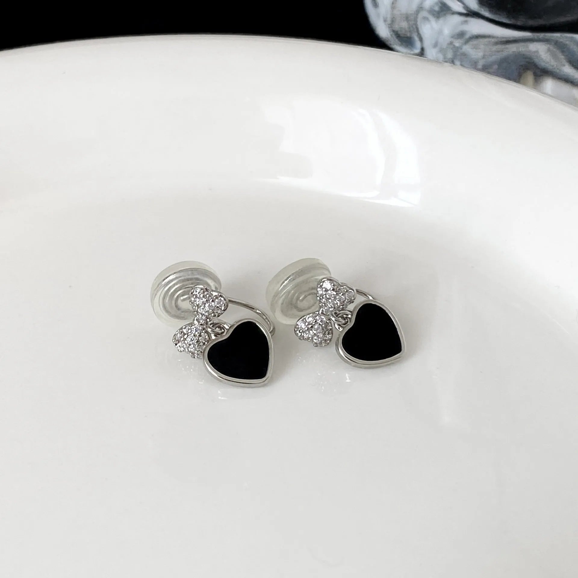 Pair of women's copper earrings, one heart-shaped and one bow-shaped, with micro-set zircon stones, ear clip and ear stud options