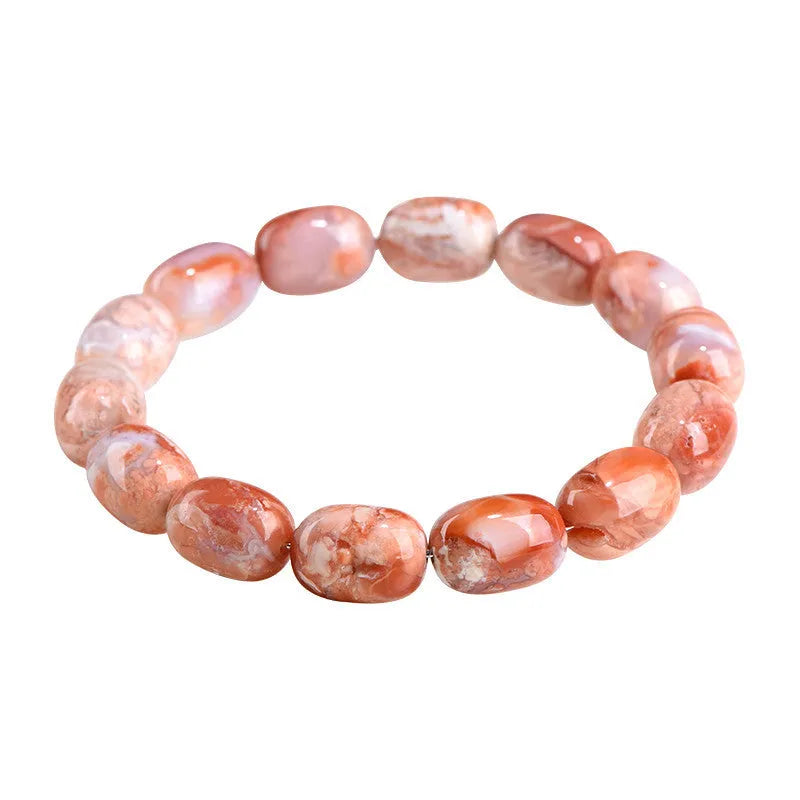 Natural cherry agate barrel bead bracelet with Ruyi symbol on a wrist.