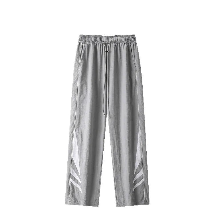 Men's black plus-size straight-leg casual trousers on a grey background, showing button detail and loose fit.