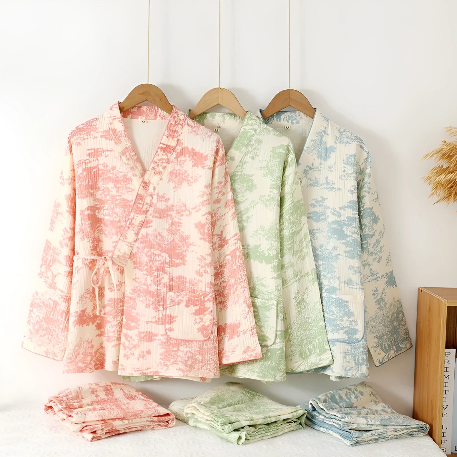 Women's pink cotton gauze lounge suit set with long sleeves and trousers laid flat.