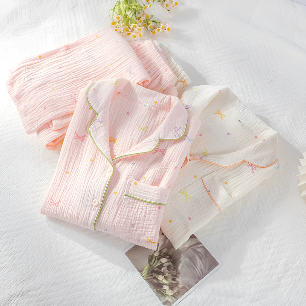 Women's pink cotton pajamas set with long sleeves and trousers on hanger