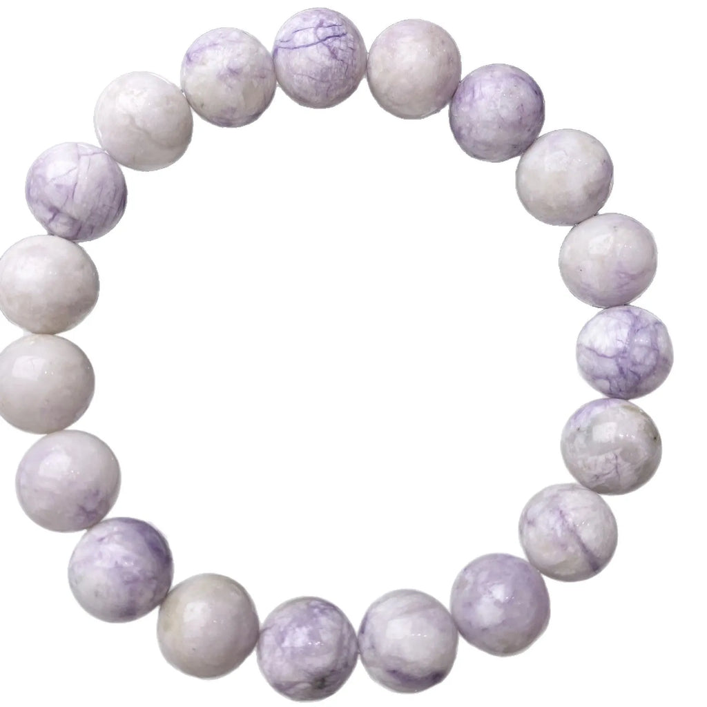 A purple turquoise bead bracelet for women showing round stone beads on a wrist.