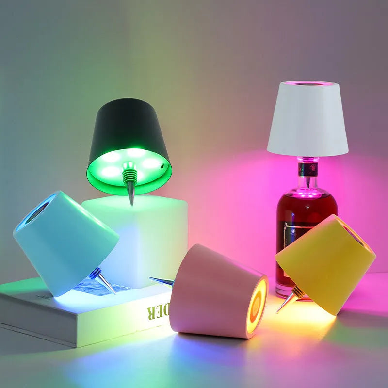 Plug-in wine bottle lamp with RGB tricolour dimming in wrought iron black finish on a table