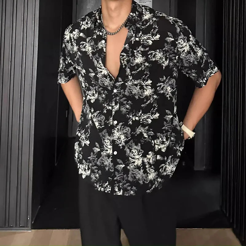 Loose-fitting floral print short sleeve shirt cardigan in black, laid flat.