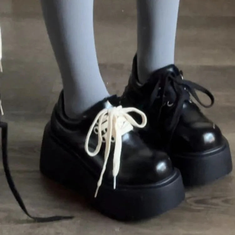Women's black matte PU leather chunky platform shoes with lace-up buckle and round toe.
