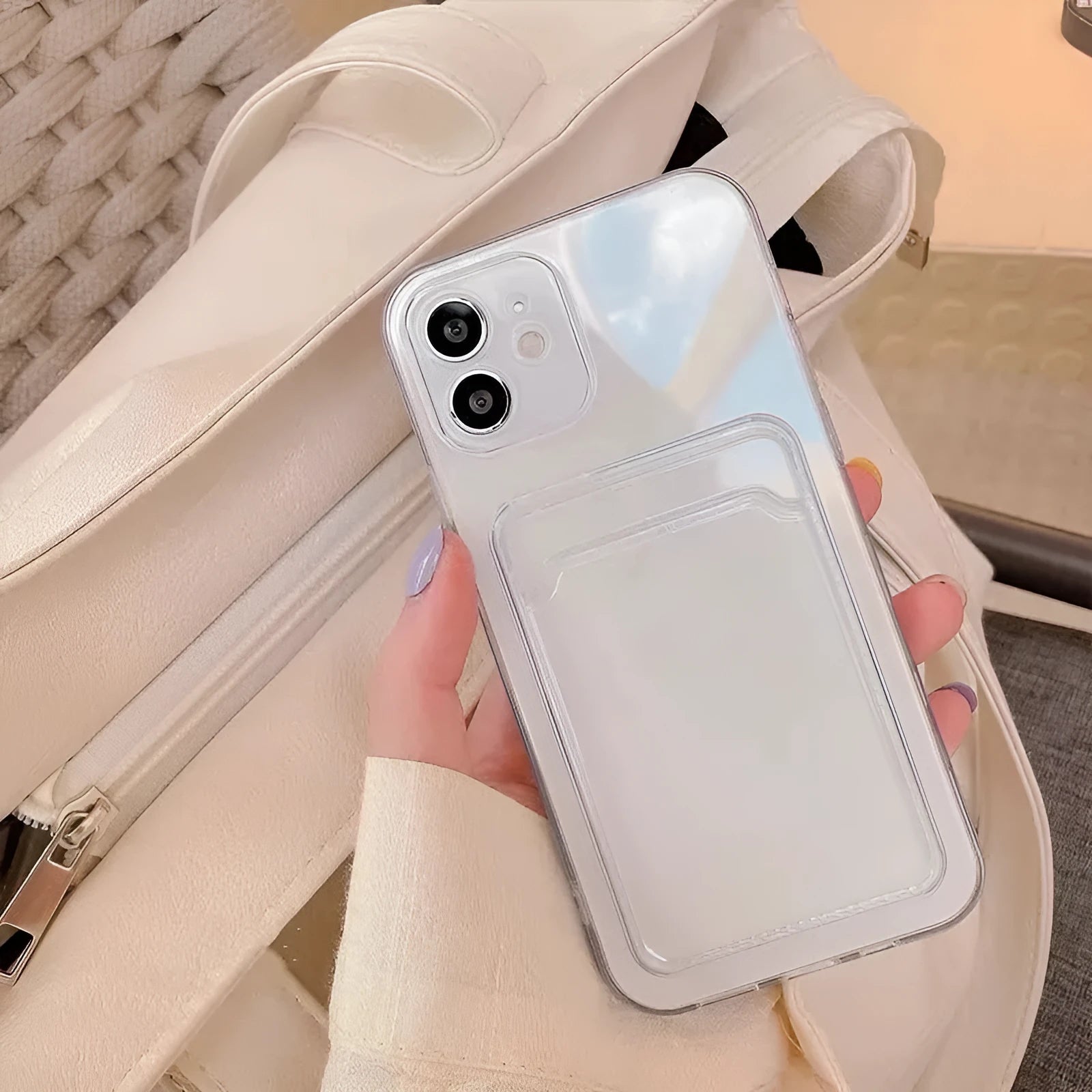 Transparent phone case with card slot for Apple iPhone on a table.