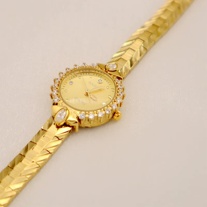 Vintage quartz bracelet watch with diamond-embossed detailing and golden face