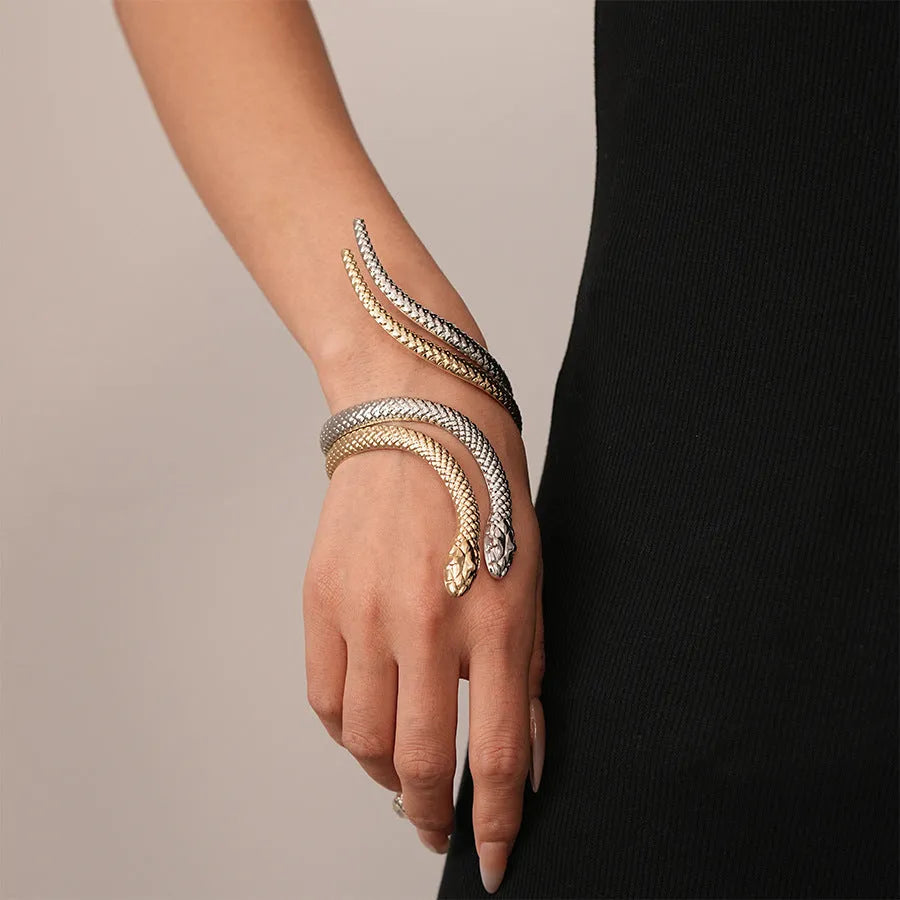 Gold exaggerated twisted winding open snake ring and bracelet jewellery set on white background.