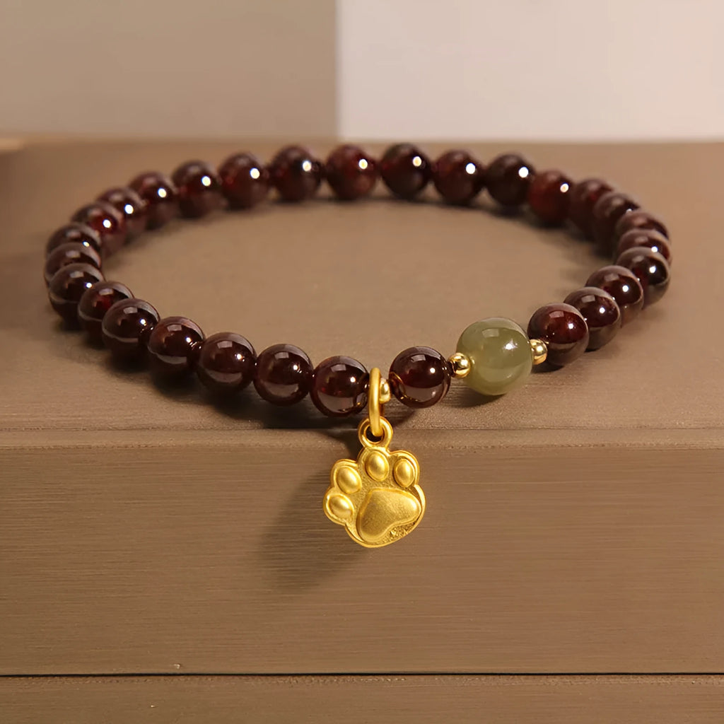 Cat's paw garnet crystal bracelet for women showing clear beads with feline charm