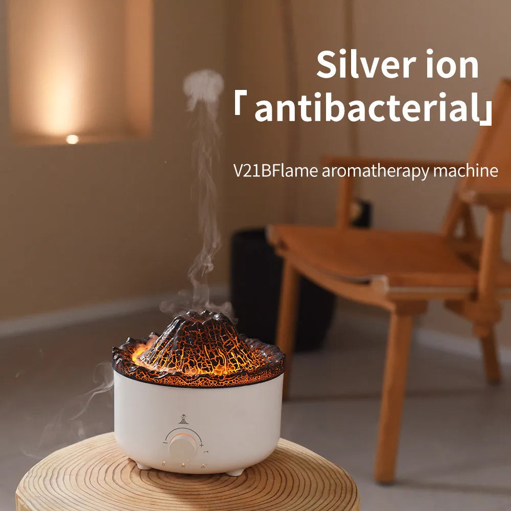 White columnar simulated flame volcano humidifier with remote control on wooden surface