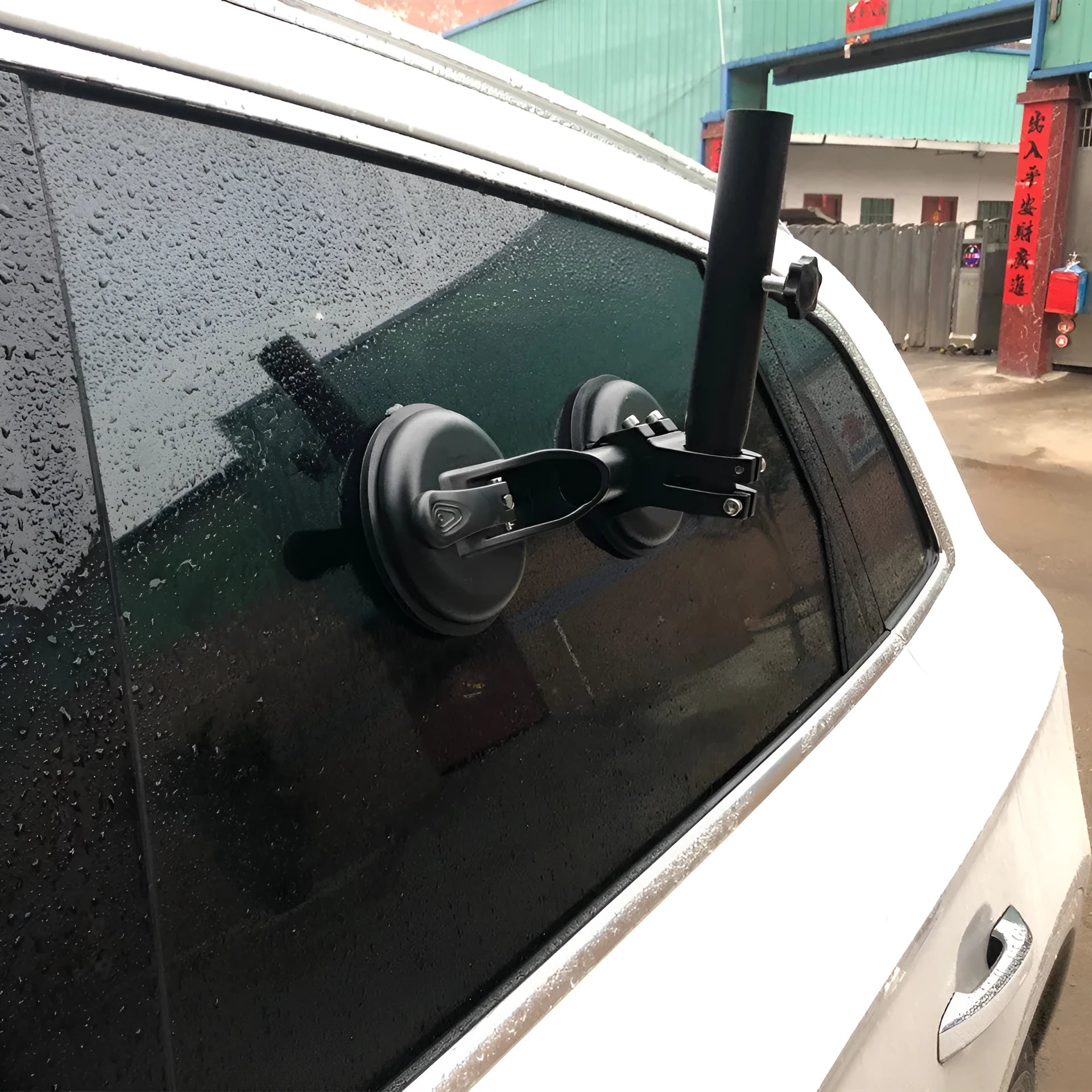 Black off-road car windscreen sucker mount with a large round rubber suction cup for flagpoles.