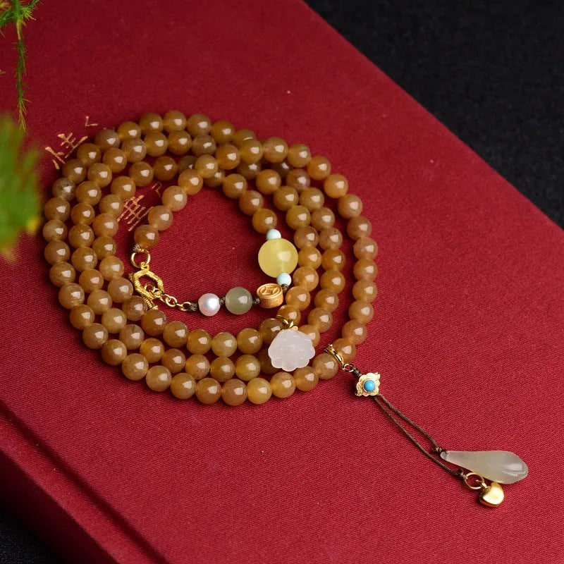Women's water green pine jade bracelet with 6mm round beads and leaf-shaped sequin details.