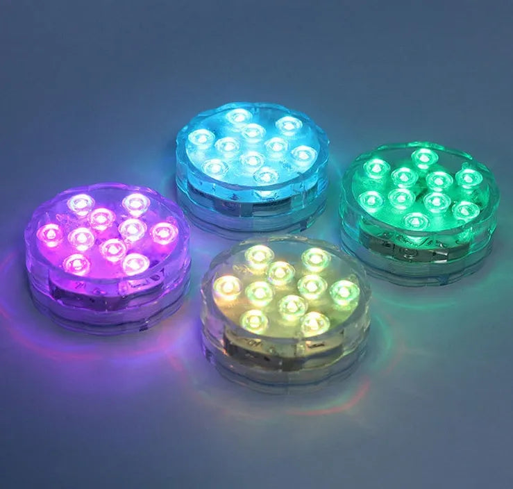 IP68 waterproof LED remote control diving light with 16 colour modes placed in a glass vase of water