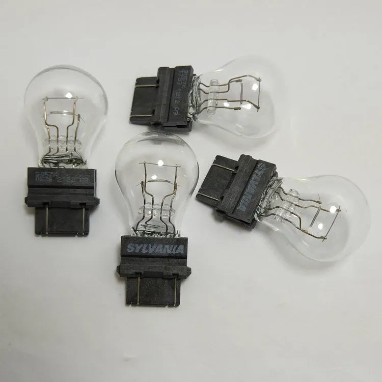 Wagner brake light bulb with yellow glass and dual wire connections for industrial equipment lighting