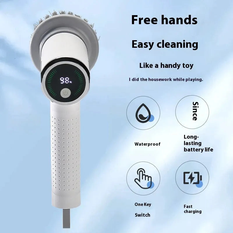White cordless electric cleaning brush with interchangeable scrubber heads on a kitchen counter