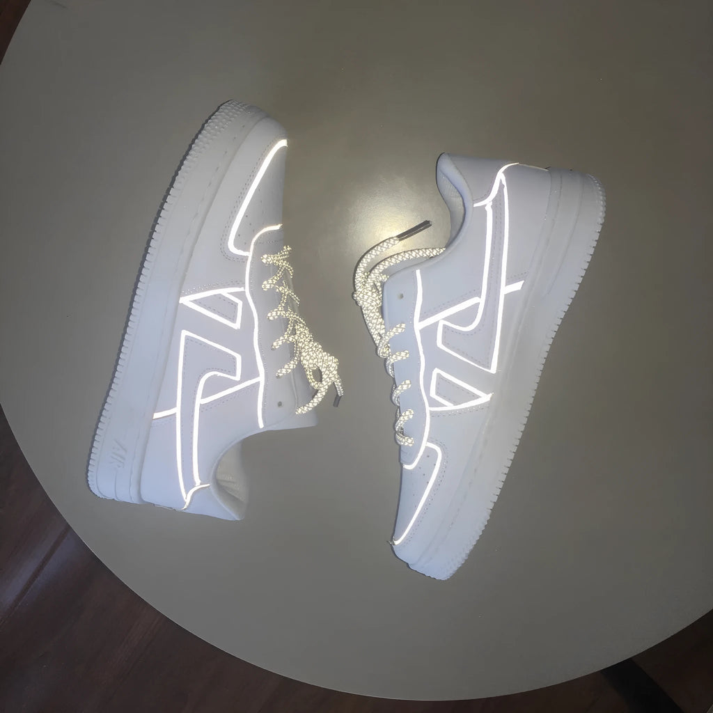 Reflective white unisex low top sneaker with lace up closure, synthetic leather upper, and TPR sole