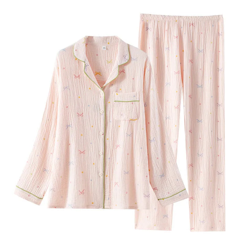 Women's pink cotton pajamas set with long sleeves and trousers on hanger