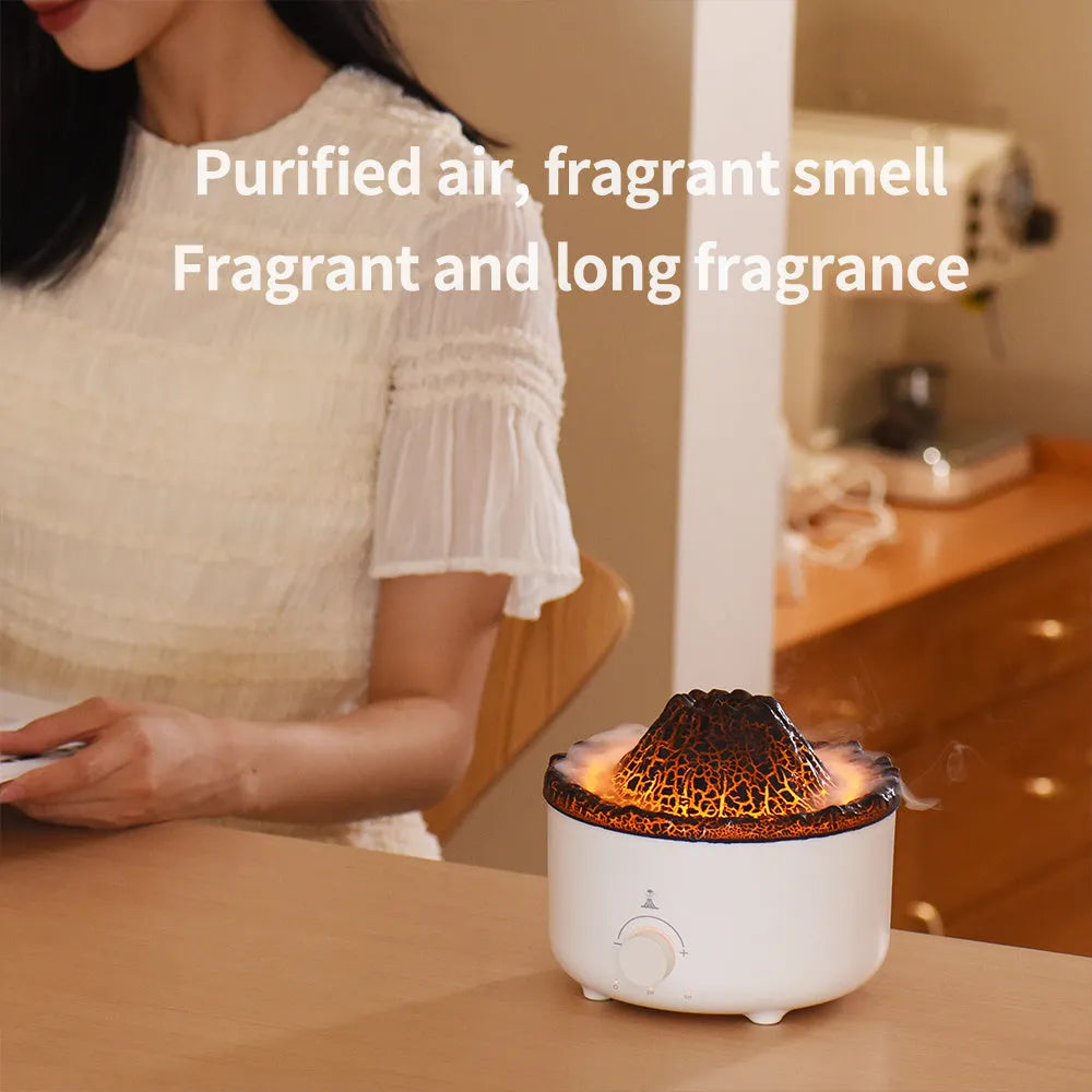 White columnar simulated flame volcano humidifier with remote control on wooden surface