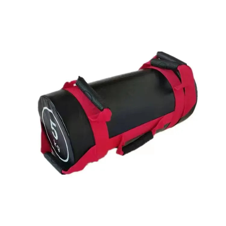 Flat white leather PVC fitness training sandbag for weight lifting on a gym floor.