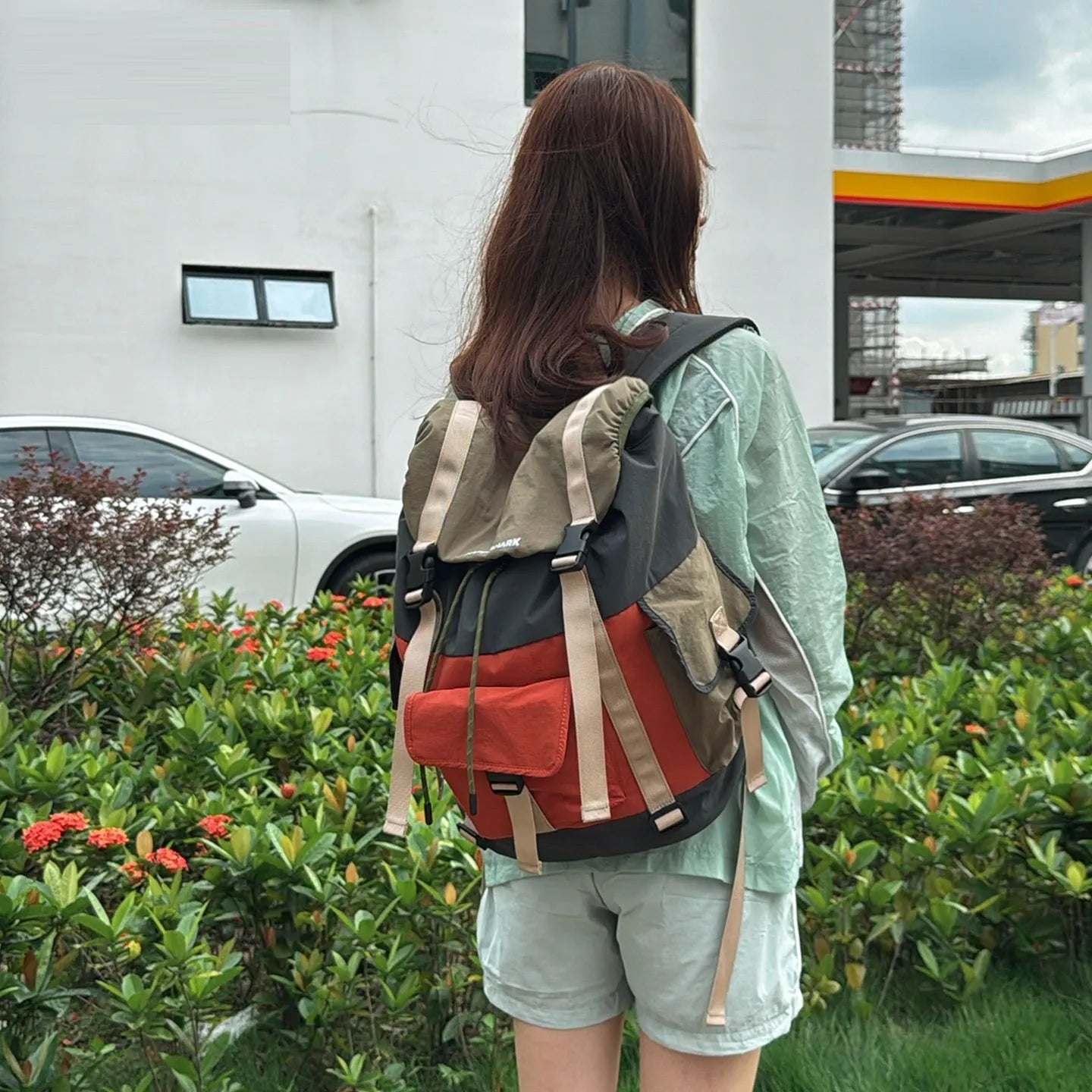 Orange-green contrast colour outdoor backpack with multiple compartments showing 35L capacity