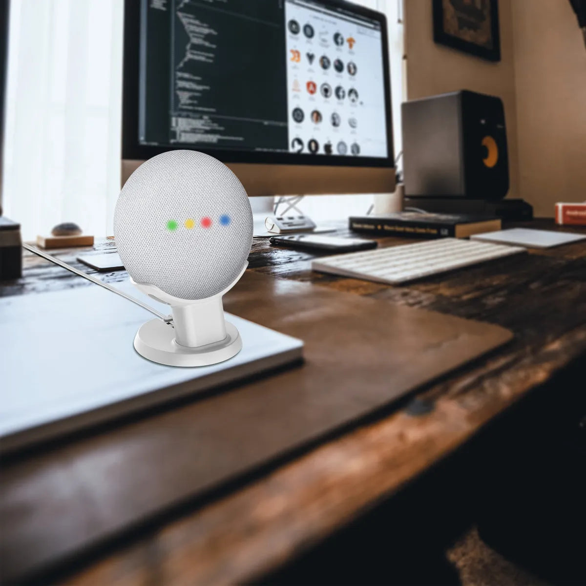 Black plastic stand holding a Google Home Mini smart speaker on a wooden table.