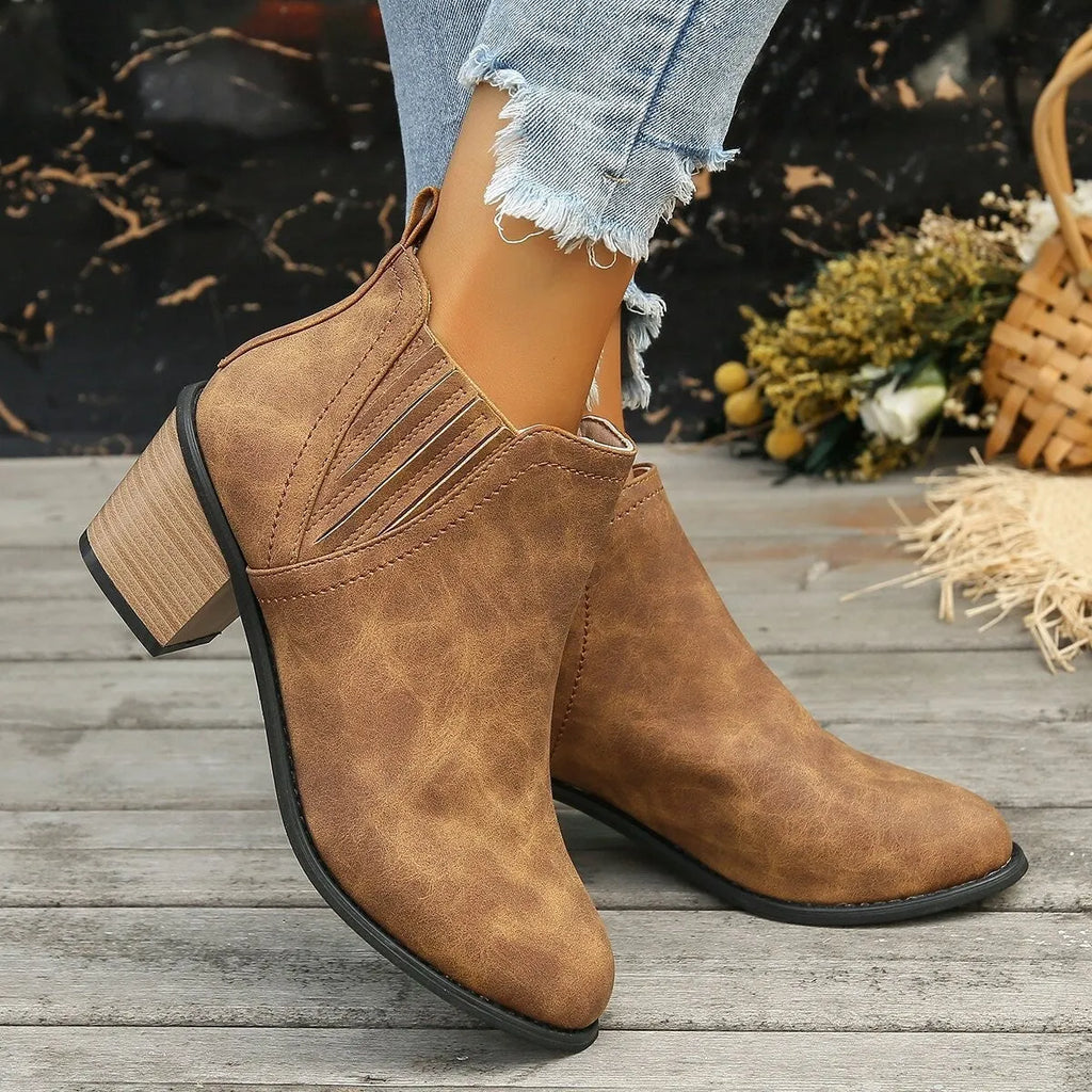 Women's black pointed toe ankle boots with thick square heel, slip-on design