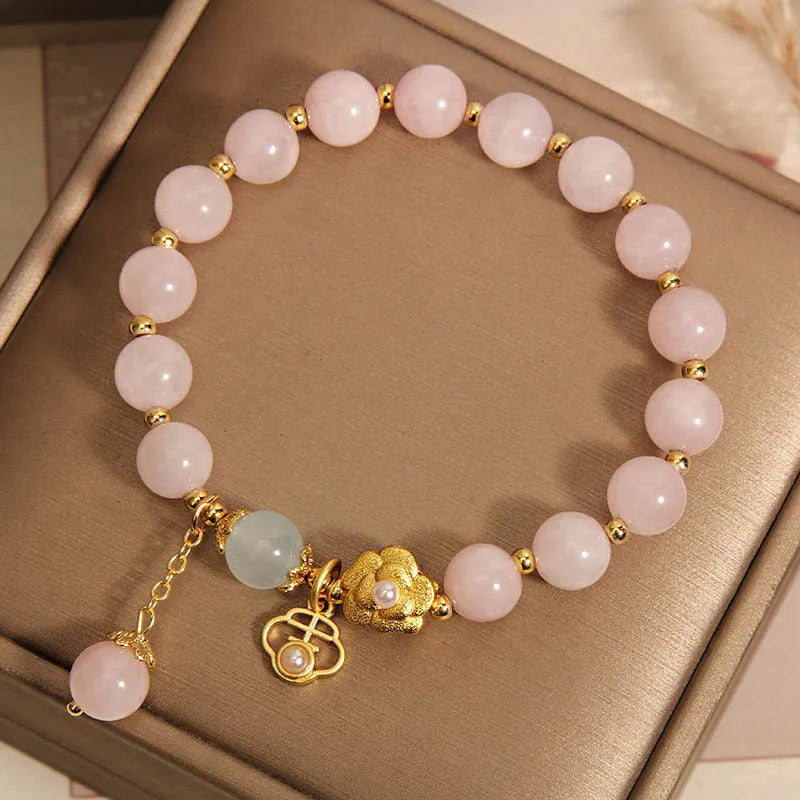 Women's pink crystal flower bracelet with floral pattern design and clasp closure