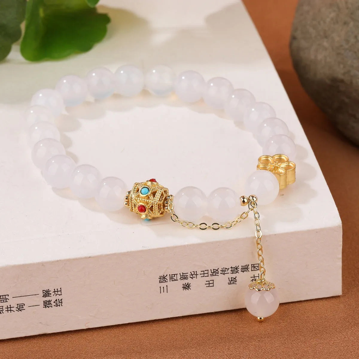 Women's agate bracelet with peach blossom copper parts and approximately 8mm beads in natural red or white stone.