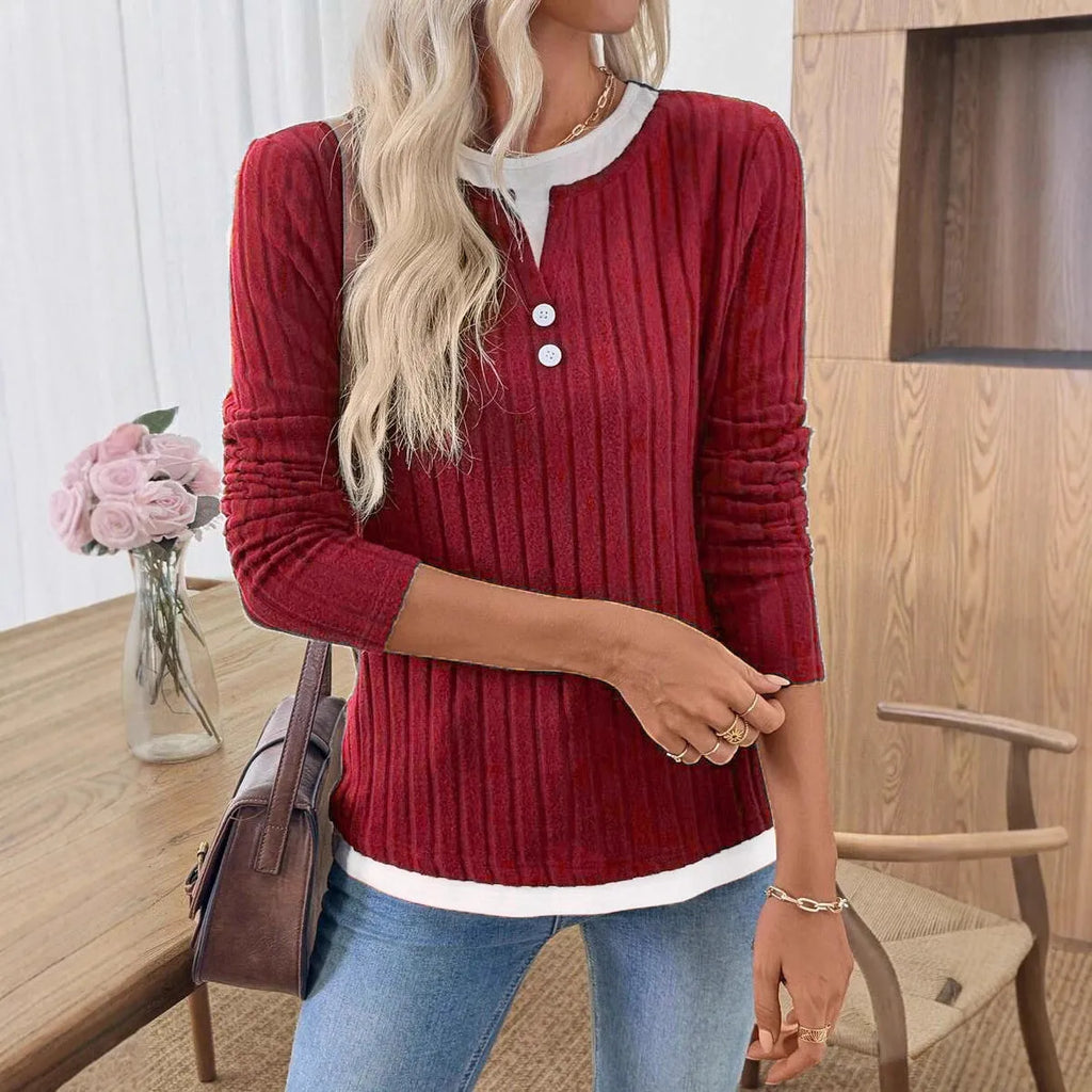 Women's black fake two-piece pullover sweater with round neck button and long sleeves on a model.