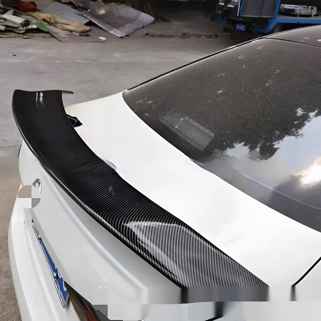 A universal punch-free ABS plastic car tail wing spoiler showing bright black, white, and carbon pattern finish options.