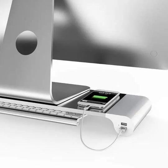 Silver and black computer monitor stand with USB ports on the front and a keyboard shelf underneath
