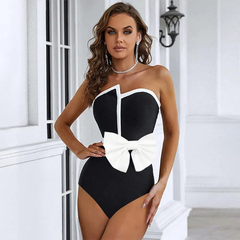 Black and white colour-block women's swimsuit with asymmetric tube top and bow detail