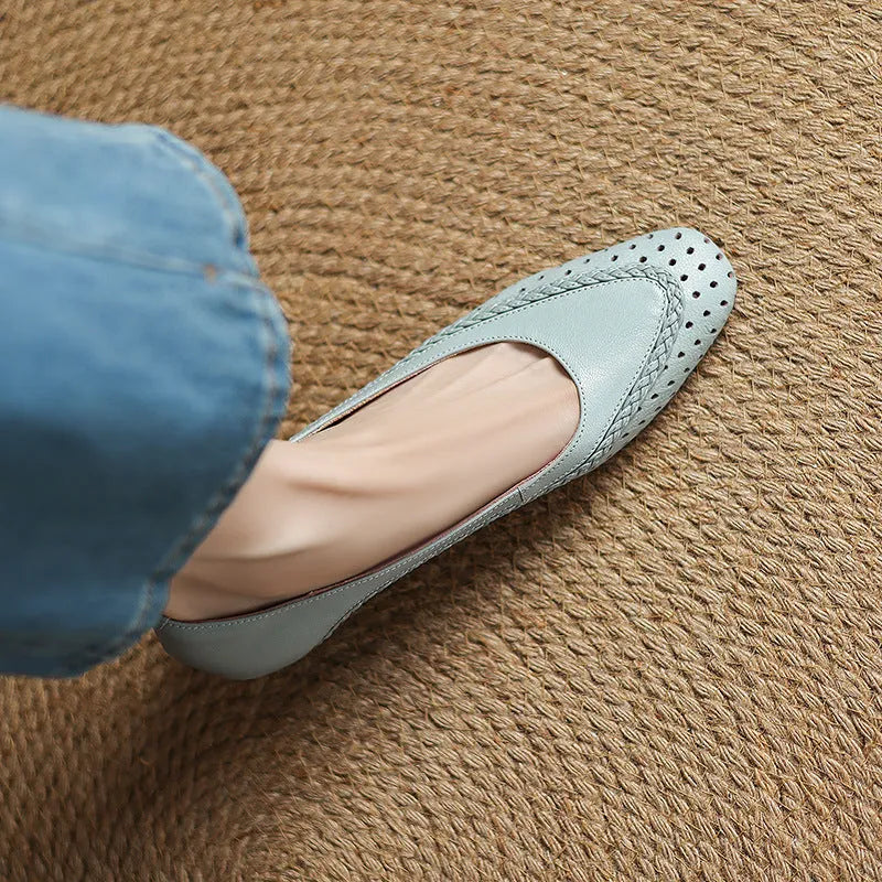 Women's beige mid-heel sandals with hollow-out design and round toe on a light background.