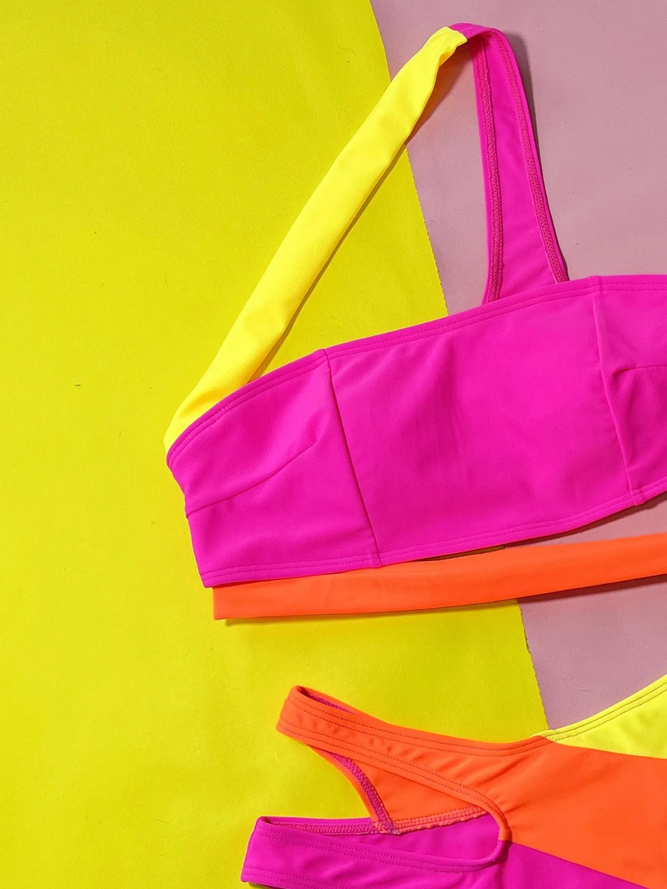 Rose red women's bikini with hollow contrast colour split design on a two-piece swimsuit set.