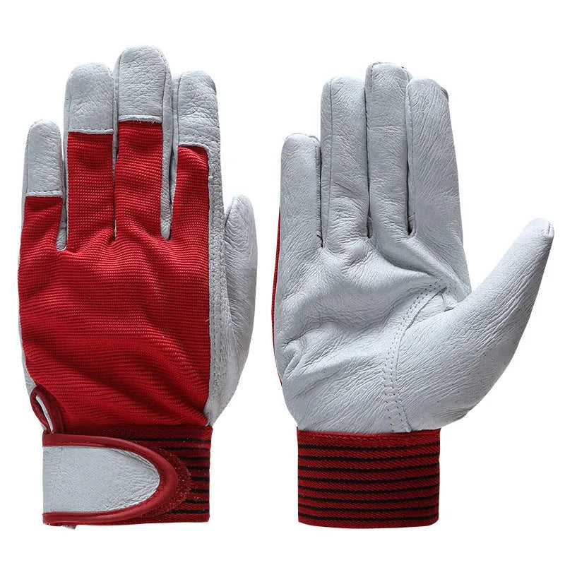 Pair of genuine pigskin labour protection work gloves in black, shown on a surface, for heavy duty construction and warehouse use