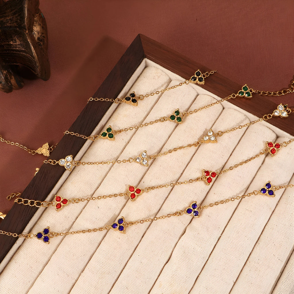 Women's stainless steel geometric bracelet with three diamond triangle design and coloured stone accents