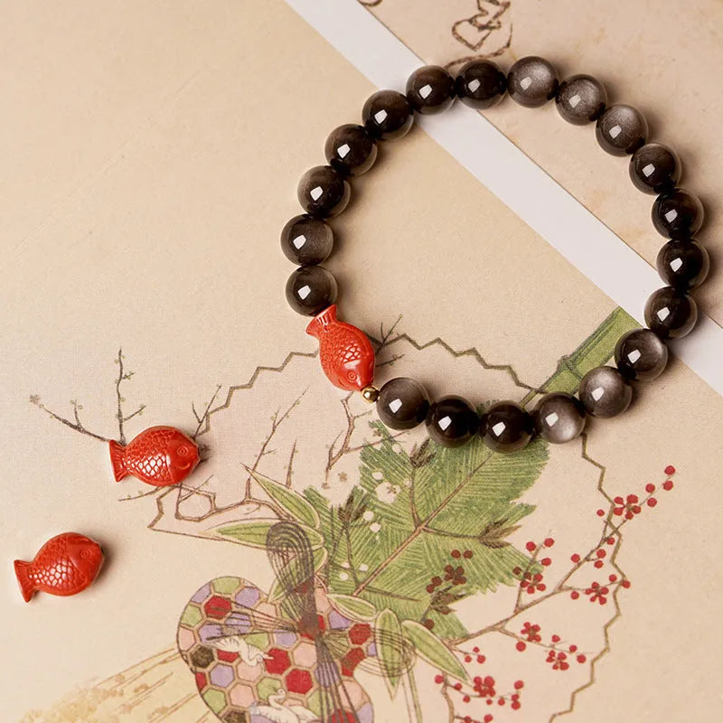 Natural obsidian round bead bracelet with red cinnabar accents and fungus decorative elements