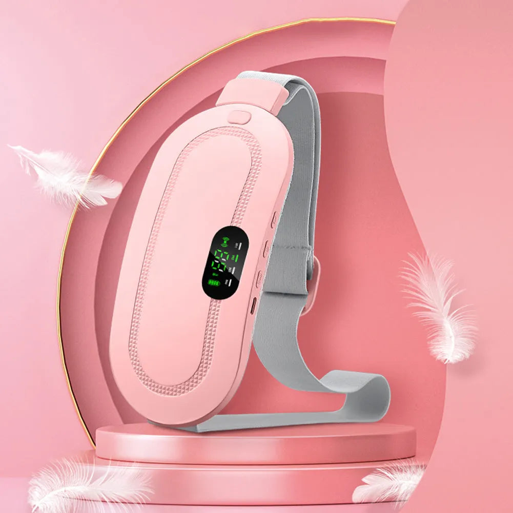 Pink and white menstrual heating belt with USB charger, controller, and long cable on a grey background.