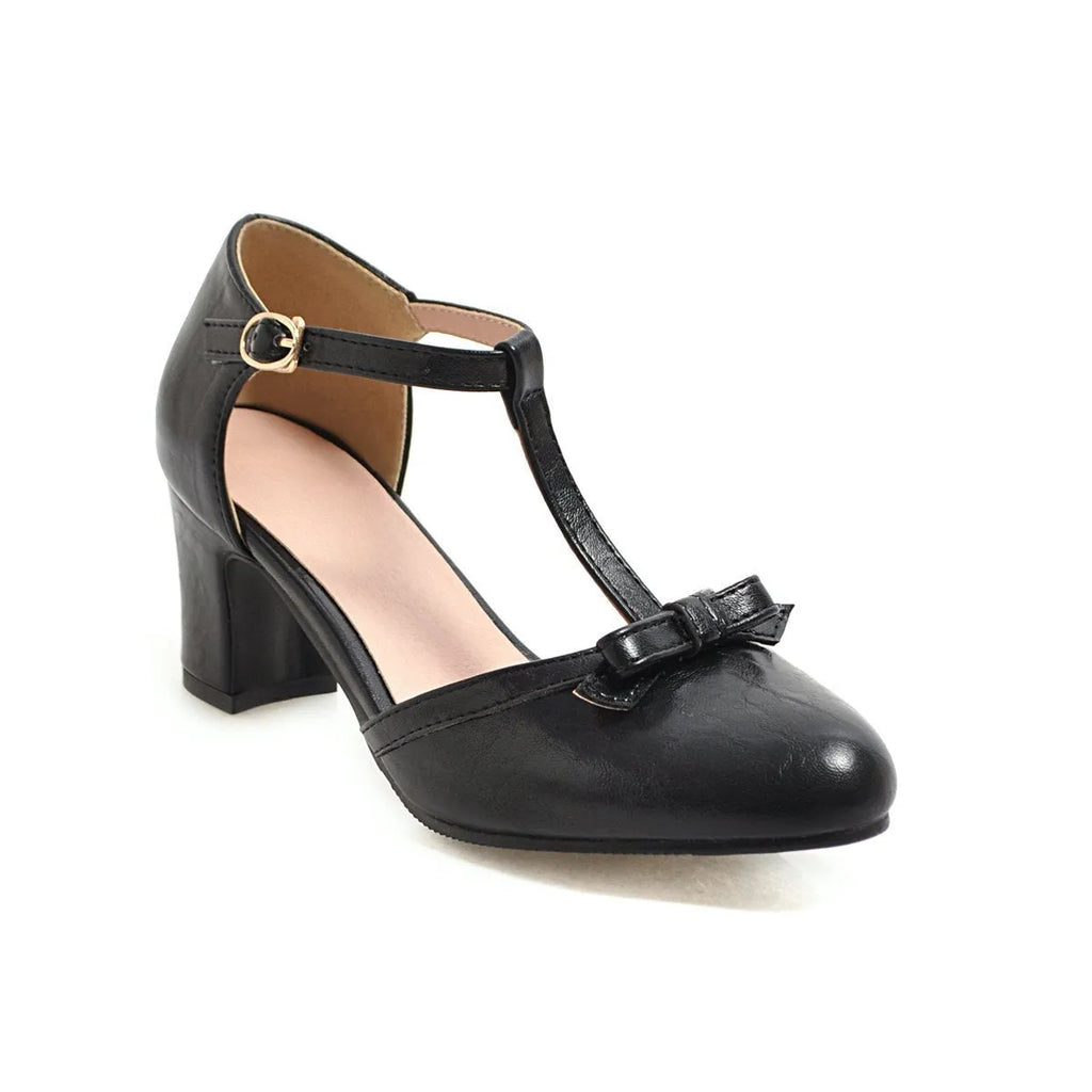 Yellow women's chunky heel sandals with a buckle strap and bow detail on a hollow-out round toe.