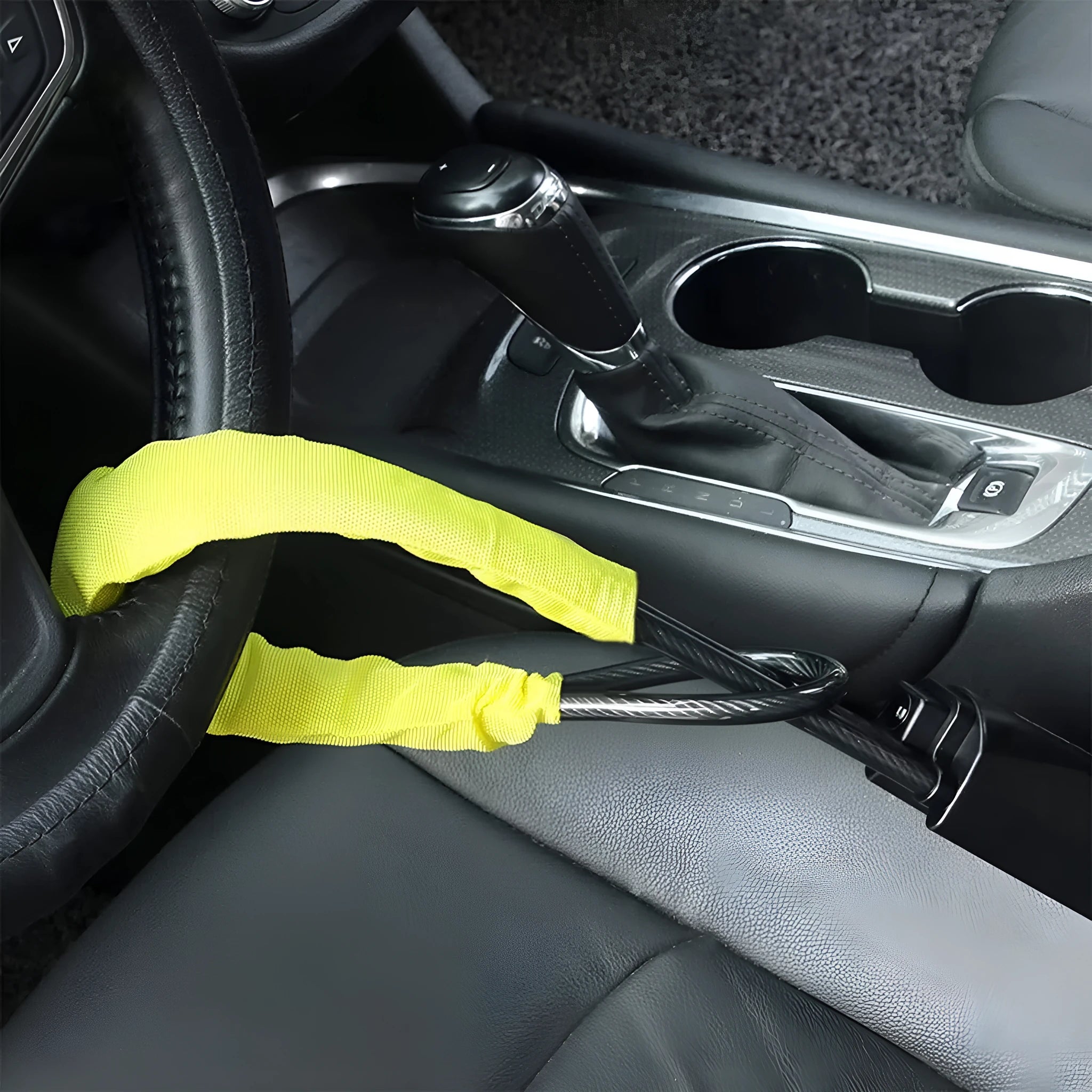 A red iron steering wheel lock with a copper core for General Motors cars, shown with its wire rope extended.