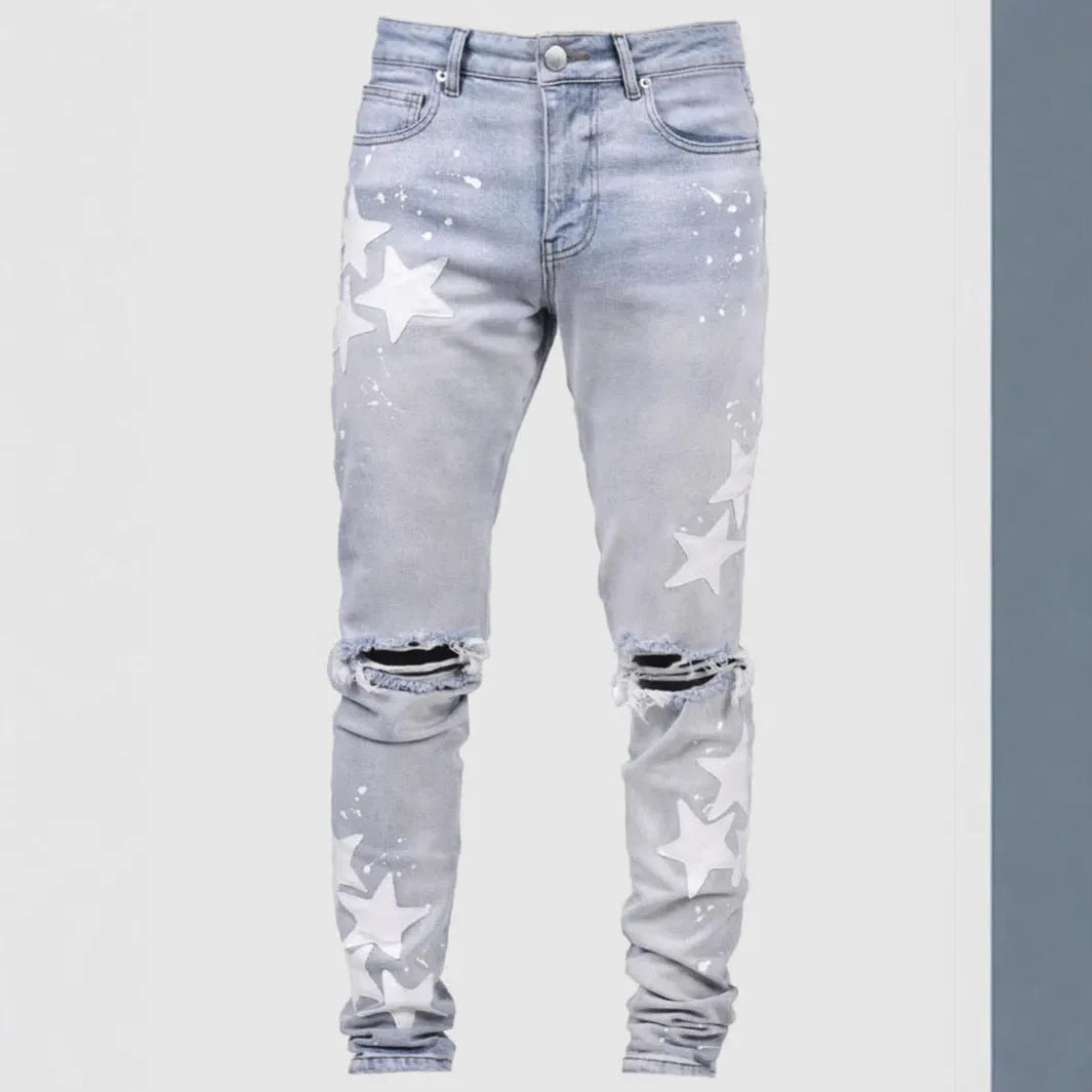 Men's slim blue jeans with embroidery detail on the leg, showing a mid-waist fit.