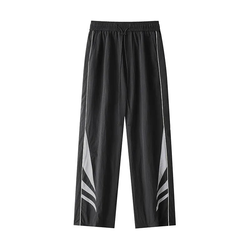 Men's black plus-size straight-leg casual trousers on a grey background, showing button detail and loose fit.